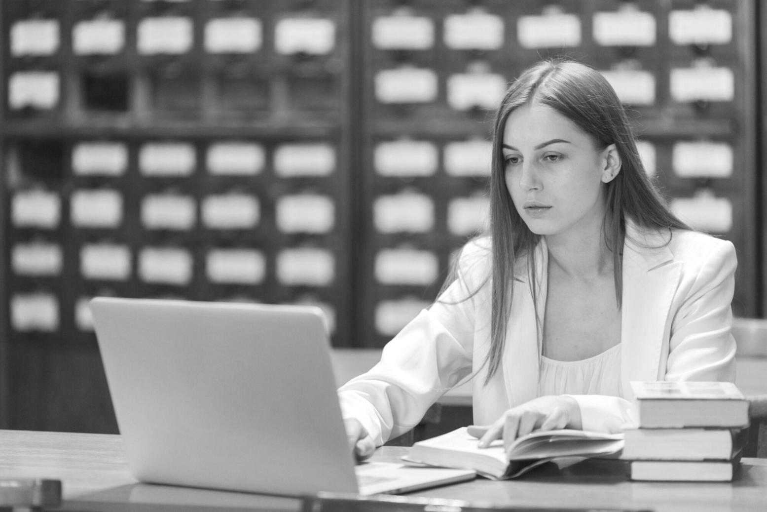 Modern financial analysis office space with multiple workstations equipped with dual monitors showing market data and analytical software